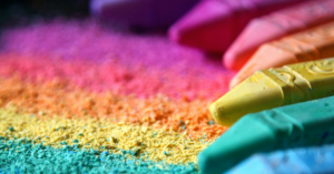 multi colored chalk spread out with a trail of chalk dust depicting color psychology